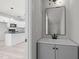 Modern powder room features gray vanity with black hardware and a sleek rectangular mirror at 2015 Cheek Rd, Durham, NC 27704