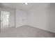 Bedroom features neutral carpet, walls, and double doors to the hallway at 2015 Cheek Rd, Durham, NC 27704