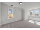 Bright bedroom with neutral carpet, two windows, and a cozy built-in window seat at 2015 Cheek Rd, Durham, NC 27704