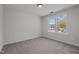 Bright bedroom with neutral carpet and paint, complemented by natural light through two windows at 2015 Cheek Rd, Durham, NC 27704