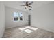Sun-filled bedroom with a modern ceiling fan and a large window showcasing the outdoor view at 2015 Cheek Rd, Durham, NC 27704