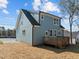 Side view of the two-story home showcasing the new deck and siding at 2015 Cheek Rd, Durham, NC 27704