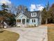Charming light blue home featuring a welcoming front porch and newly paved driveway at 2015 Cheek Rd, Durham, NC 27704