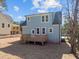 Angle of the rear of the property showcasing the two-story home and backyard deck at 2015 Cheek Rd, Durham, NC 27704