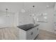 Open concept kitchen with island, modern pendant lights, and sleek countertops at 2015 Cheek Rd, Durham, NC 27704
