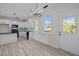 Well-lit kitchen and dining area with backyard views, modern lighting, and black appliances at 2015 Cheek Rd, Durham, NC 27704