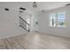 Bright living room boasts light wood floors, staircase, modern lighting, and fresh white paint at 2015 Cheek Rd, Durham, NC 27704