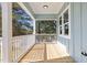 Outdoor porch showcasing blue siding, white railings, and wood flooring at 2015 Cheek Rd, Durham, NC 27704