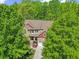 Aerial shot of the home, surrounded by mature trees and beautifully landscaped grounds at 208 Bellagio Dr, Apex, NC 27539