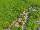 Scenic aerial view of a neighborhood nestled amidst lush greenery and winding streets at 208 Bellagio Dr, Apex, NC 27539