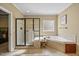 Modern bathroom boasting a glass-enclosed shower and soaking tub at 208 Bellagio Dr, Apex, NC 27539