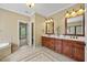 A bathroom features double vanity sinks and a separate soaking tub at 208 Bellagio Dr, Apex, NC 27539