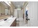 Bathroom featuring a granite vanity, framed mirror, tiled shower-tub, and a walk-in closet at 208 Bellagio Dr, Apex, NC 27539