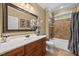 Bathroom featuring a single sink vanity with updated fixtures and a shower-tub combo at 208 Bellagio Dr, Apex, NC 27539
