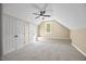 Upstairs bedroom featuring a ceiling fan, natural light, and spacious closets at 208 Bellagio Dr, Apex, NC 27539