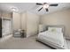 Bedroom with neutral carpet, ceiling fan, accent chair, and a comfy bed at 208 Bellagio Dr, Apex, NC 27539