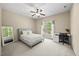 Bright bedroom features a ceiling fan, a large window for natural light, and neutral walls at 208 Bellagio Dr, Apex, NC 27539