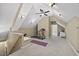 Bonus room or attic space with sloped ceilings, carpeted floor, and a treadmill at 208 Bellagio Dr, Apex, NC 27539
