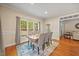 Bright dining area featuring a wood table, upholstered chairs, and a large window offering natural light at 208 Bellagio Dr, Apex, NC 27539