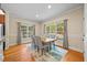 Dining area with wood floors, large windows and an area rug under the table at 208 Bellagio Dr, Apex, NC 27539