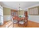 Charming dining room with hardwood floors, wainscoting, and a view into the kitchen at 208 Bellagio Dr, Apex, NC 27539