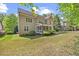 View of the home's exterior, showcasing the porch and a spacious backyard at 208 Bellagio Dr, Apex, NC 27539