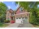 Beautiful two-story home featuring a two-car garage, stone accents, and a well-manicured lawn at 208 Bellagio Dr, Apex, NC 27539
