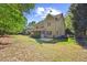 View of the home's exterior, showcasing the porch, patio, and a spacious backyard at 208 Bellagio Dr, Apex, NC 27539