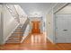 Grand foyer with hardwood floors, staircase with iron railings, and an elegant front door at 208 Bellagio Dr, Apex, NC 27539