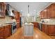 Well-appointed kitchen with stainless appliances, custom cabinetry, granite countertops, and a center island at 208 Bellagio Dr, Apex, NC 27539