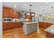 Spacious kitchen featuring custom cabinets, stainless steel appliances, granite countertops, and an island at 208 Bellagio Dr, Apex, NC 27539