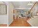 Open-concept living room featuring hardwood floors, fireplace, and abundant natural light at 208 Bellagio Dr, Apex, NC 27539