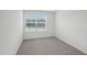 Bedroom with neutral carpet and a bright window with views of the neighborhood at 2107 Glen Crossing Dr, Durham, NC 27704
