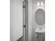 Clean powder room with pedestal sink, decorative mirror, and modern fixtures at 2107 Glen Crossing Dr, Durham, NC 27704