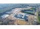 Aerial view of a new construction community with a pond and wooded areas at 2109 Glen Crossing Dr, Durham, NC 27704
