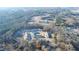 Wide aerial view of a new townhome construction, a pond, and wooded areas at 2109 Glen Crossing Dr, Durham, NC 27704