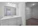 Bathroom featuring a large mirror over a single sink vanity and a glimpse of a closet at 2109 Glen Crossing Dr, Durham, NC 27704