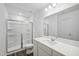 Bathroom with a glass enclosed shower, toilet and vanity with a large framed mirror at 2109 Glen Crossing Dr, Durham, NC 27704