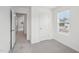 Bright bedroom with neutral carpet, a window, and a door leading to the hallway at 2109 Glen Crossing Dr, Durham, NC 27704