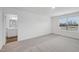 Light filled bedroom with gray carpet, white walls and a window overlooking the exterior at 2109 Glen Crossing Dr, Durham, NC 27704