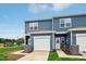 Charming blue two-story townhome with a one-car garage and well-maintained lawn at 2109 Glen Crossing Dr, Durham, NC 27704