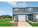 Charming blue two-story townhome with a one-car garage and well-maintained lawn at 2109 Glen Crossing Dr, Durham, NC 27704