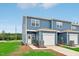 Charming blue two-story townhome with a one-car garage and well-maintained lawn at 2109 Glen Crossing Dr, Durham, NC 27704