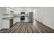Modern kitchen features stainless appliances, granite countertops, and wood-look floors at 2109 Glen Crossing Dr, Durham, NC 27704