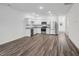Open-concept kitchen featuring stainless steel appliances, granite countertops, and modern white cabinetry at 2109 Glen Crossing Dr, Durham, NC 27704