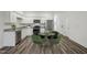 Well-lit kitchen features white cabinets, stainless steel appliances, and an adjacent dining area at 2109 Glen Crossing Dr, Durham, NC 27704