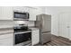 Kitchen features stainless appliances, granite countertops, and white cabinetry at 2109 Glen Crossing Dr, Durham, NC 27704