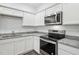 Modern kitchen with stainless steel appliances, granite countertops, and ample cabinet space at 2109 Glen Crossing Dr, Durham, NC 27704