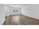 Living room with wood-look floors, natural light and entry door at 2109 Glen Crossing Dr, Durham, NC 27704