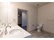 A modern bathroom features dual sinks, sleek fixtures, and neutral tile flooring at 2205 Gathering Square Ct, Fuquay Varina, NC 27526